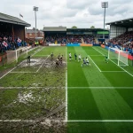 A professional soccer field split showing British muddy pitch and pristine American field
